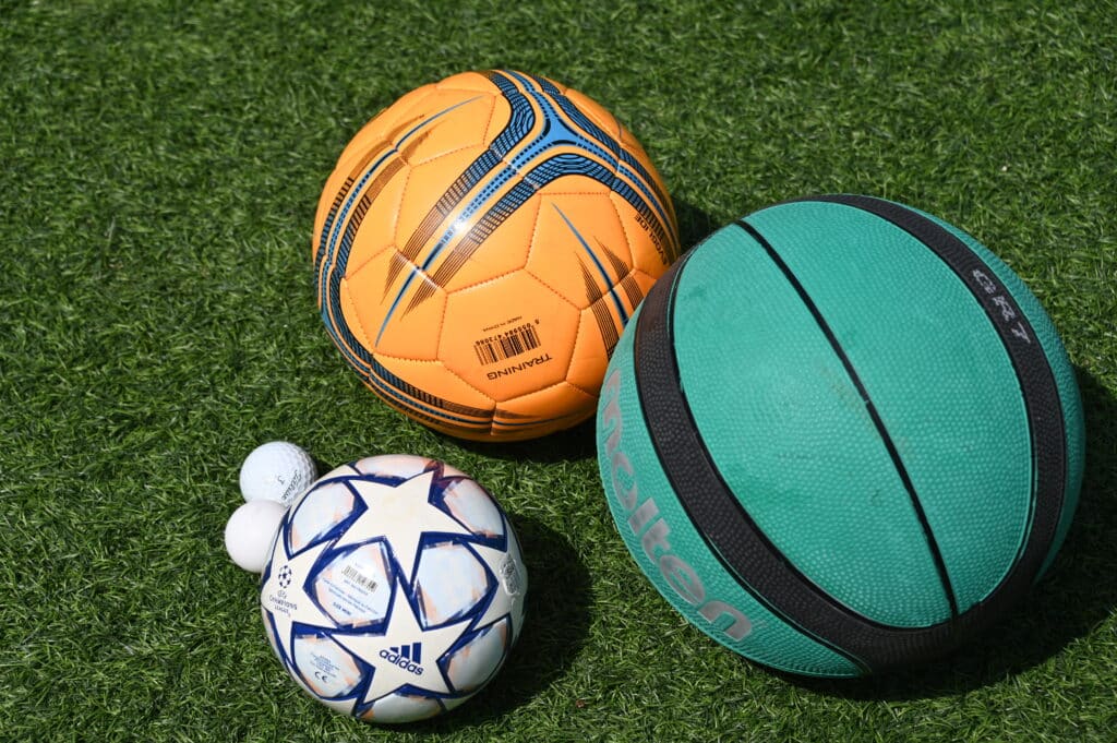 a basketball, football, golf ball and table tennis ball for a ball drop science activity