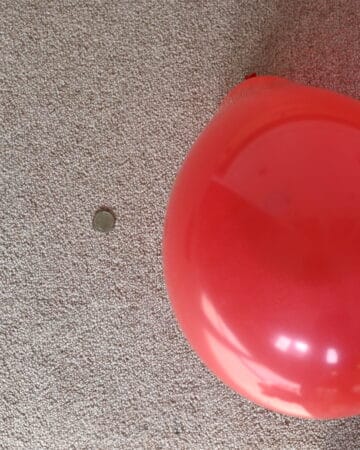 A balloon blown up and small coin